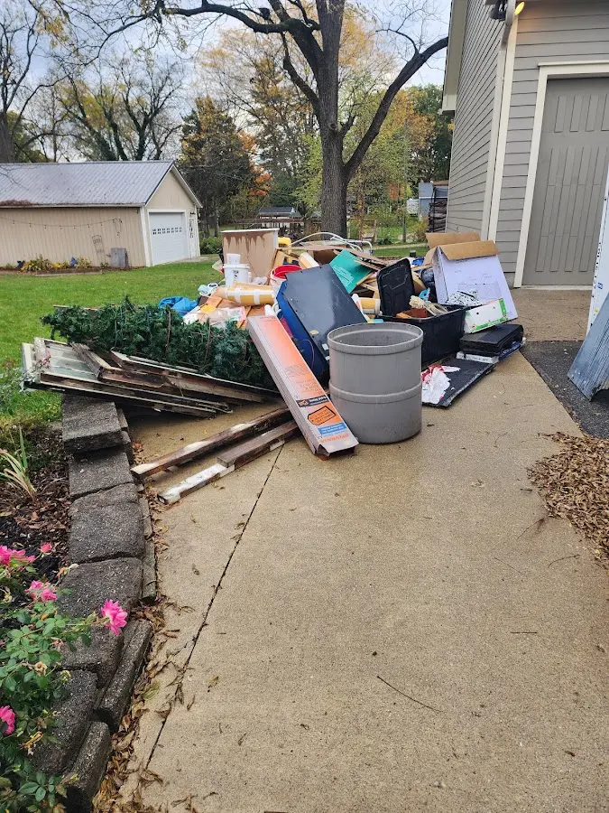Dumpster being loaded with debris for Roofing Dumpster Rental in Whitehall